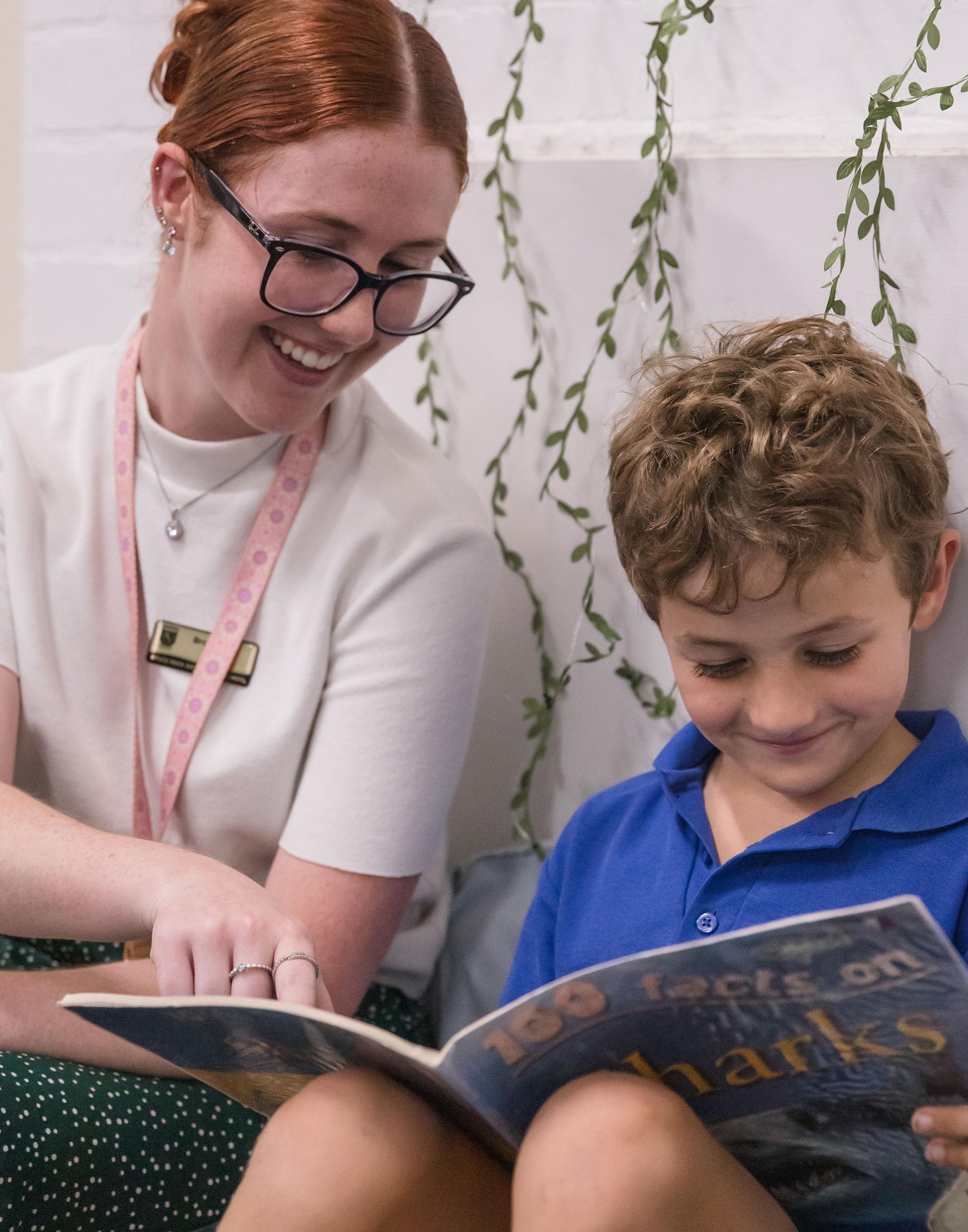 Teacher and boy reading